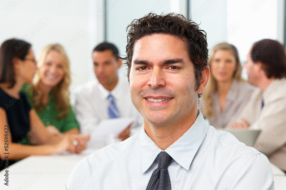 Portrait Of Businessman Sitting At Boardroom Table Portrait Of Businessman Sitting At Boardroom Table