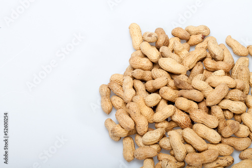 .Dried peanuts in closeup on the white background