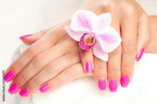 beautiful manicure with pink orchid and towel