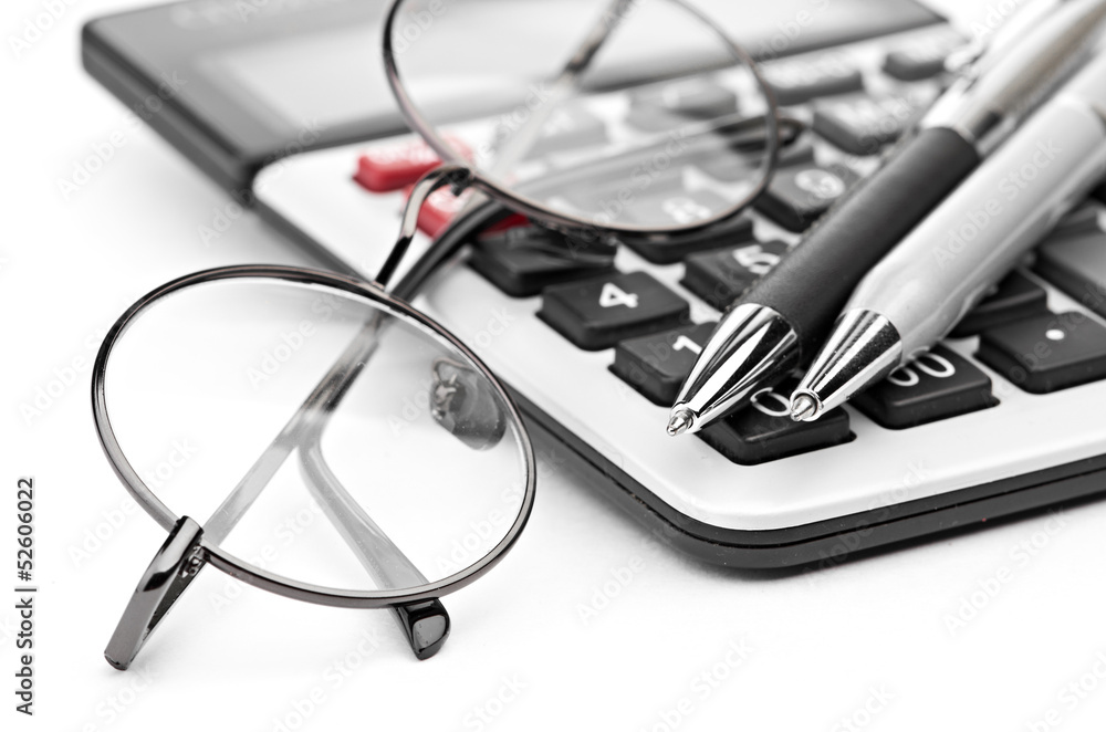 glasses and pen on calculator glasses and pen on calculator