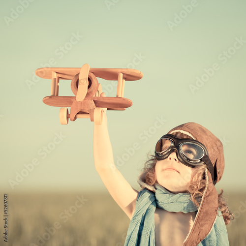 Happy kid playing with toy airplane