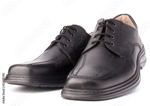 Black glossy man’s shoes with shoelaces