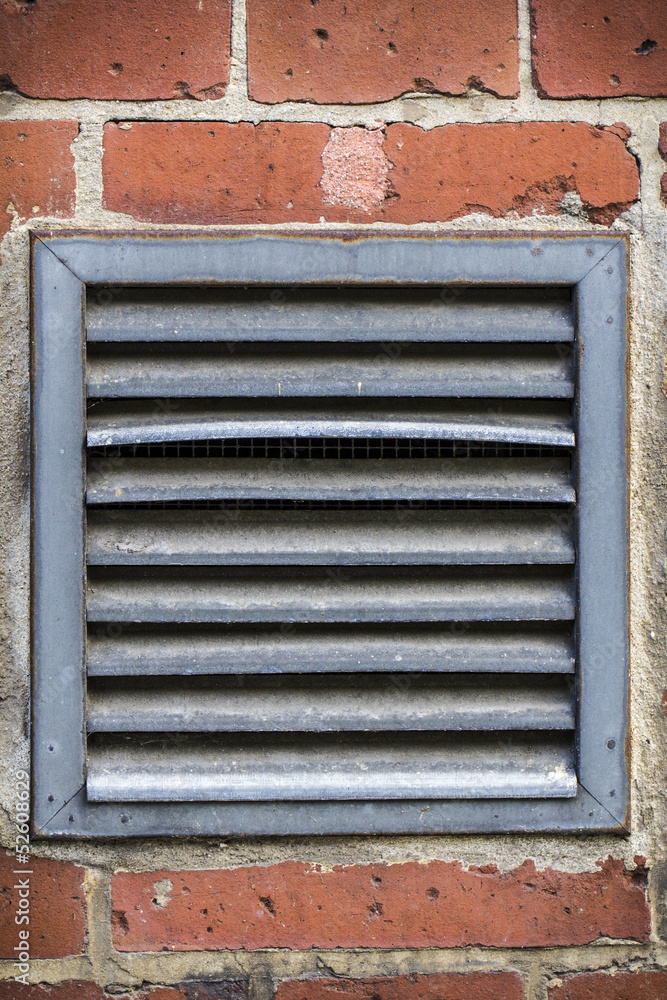 outdoor ventilation on a red brickwall
