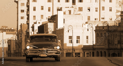 A classic car driving the Malecon, Havana, Cuba
