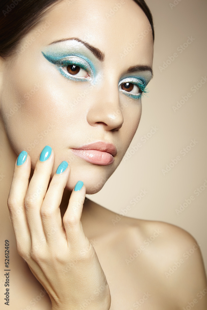 Fototapeta premium Beautiful young woman with bright make-up and manicure