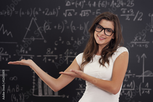 Woman wearing in glasses showing mathematical formulas