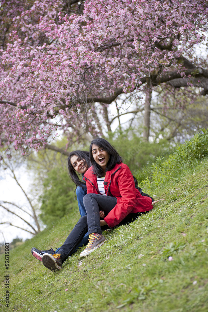 mother and daughter relaxing in park