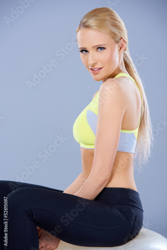 Adorable fitness woman sitting on ball