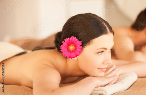 woman in spa with hot stones