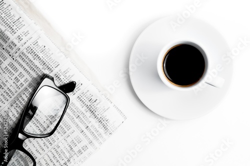 coffee near financial newspaper and glasses