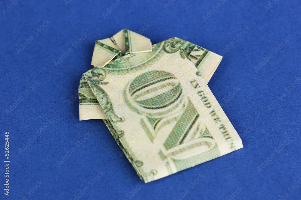Dollar folded into shirt on blue background Dollar folded into shirt on blue background