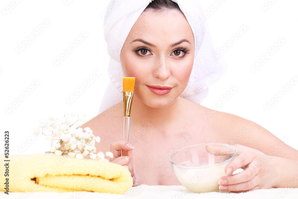 Beautiful young woman with cream for face mask and towel Beautiful young woman with cream for face mask and towel
