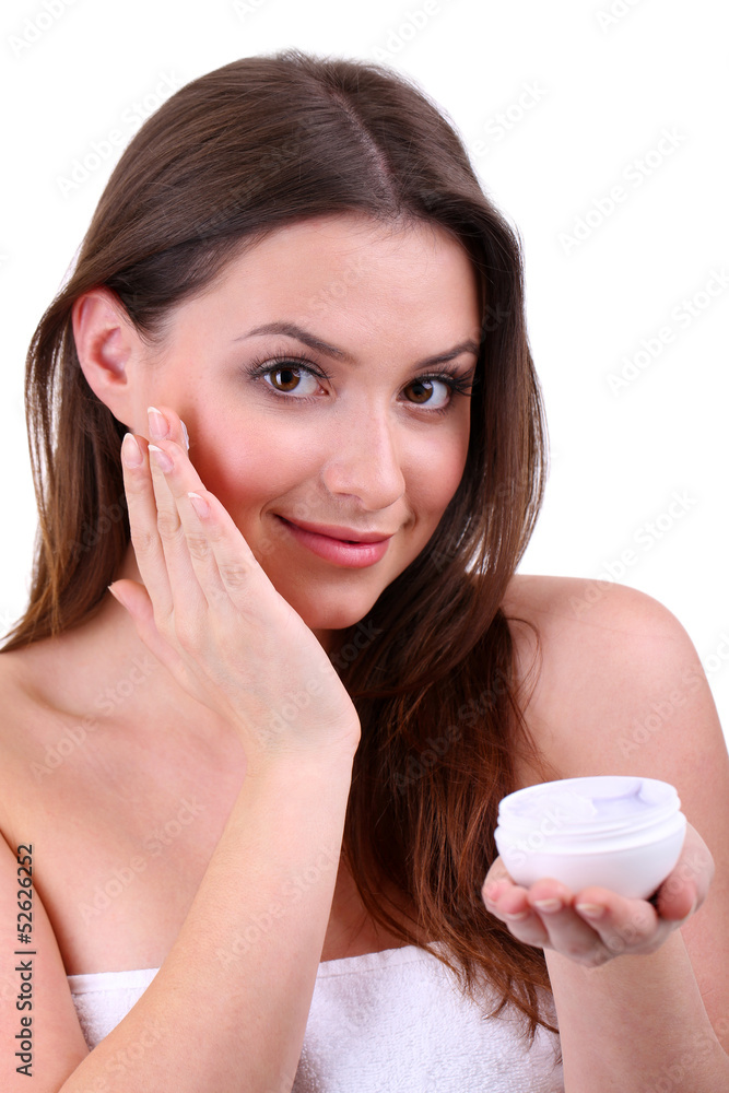 Woman applying lifting cream from container Woman applying lifting cream from container