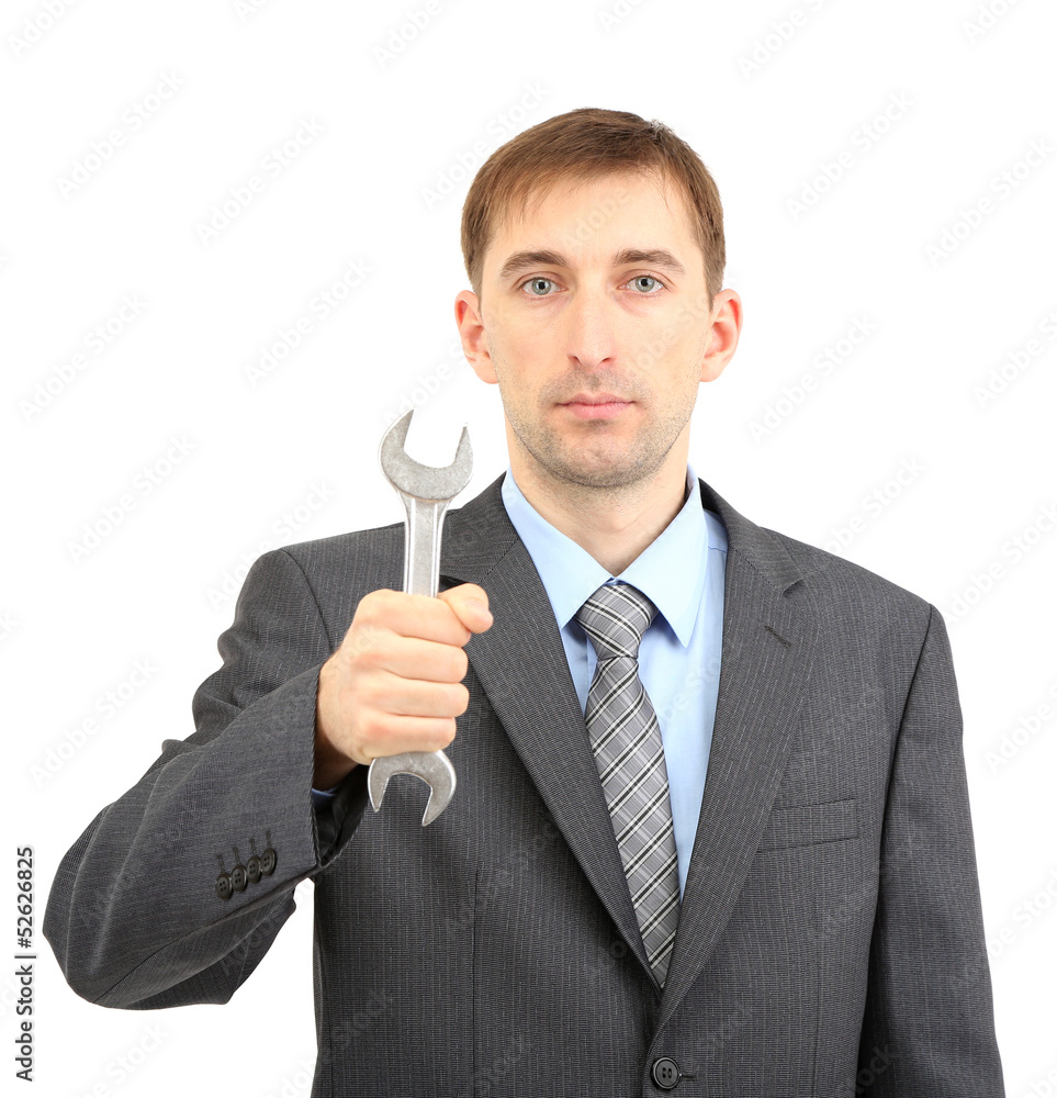 Young businessman with wrench isolated on white. Young businessman with wrench isolated on white.