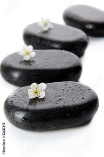 Spa stones and white flowers isolated on white