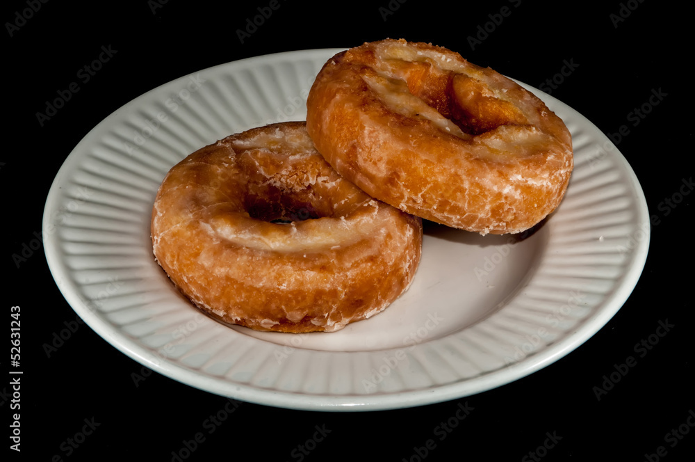 Glazed Donut Isolated on a Black Background Glazed Donut Isolated on a Black Background