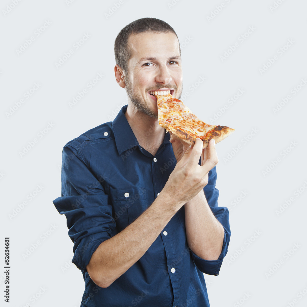 portrait of a young beautiful man eating a slice of pizza marghe portrait of a young beautiful man eating a slice of pizza marghe