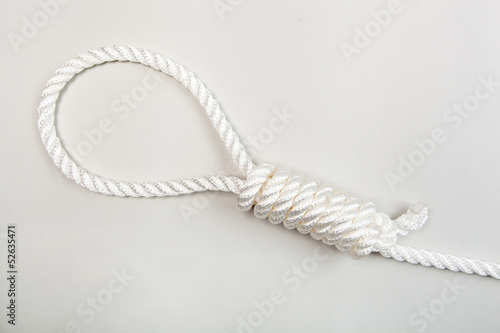 Nylon rope with hangman knot on a grey background