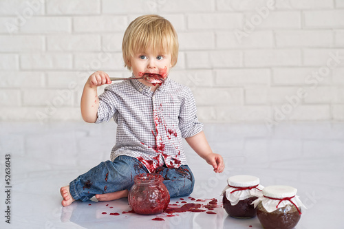 Cute little boy got messy eating strawberry