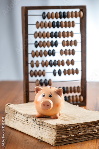 Piggy bank on old book photo