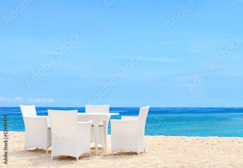 Luxury white chairs and table on white sandy beach photo