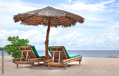 Relaxing couch chairs on white sandy Beach