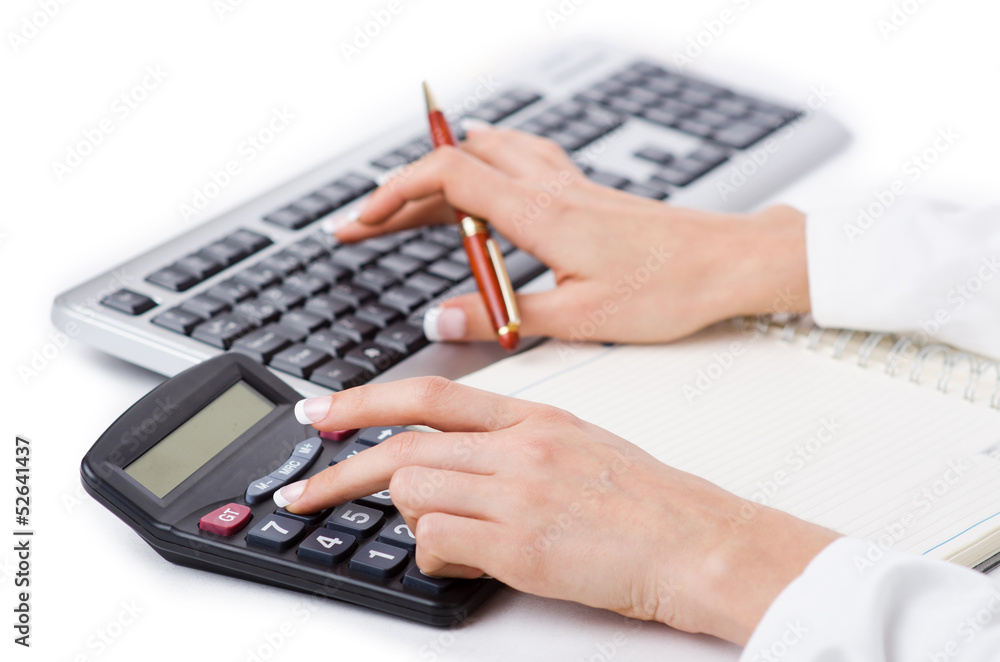 Hands working on the calculator Hands working on the calculator