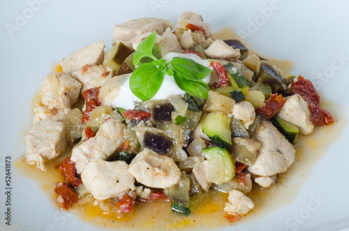 Garnished chicken with dried tomatoes, aubergine, zucchini and b