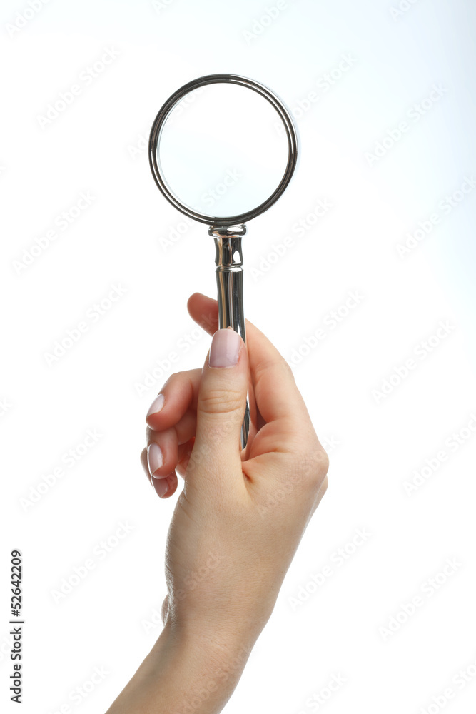 Hand holding a magnifying glass Hand holding a magnifying glass