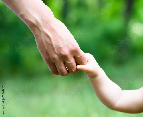 Hands of mother and daughter holding each other