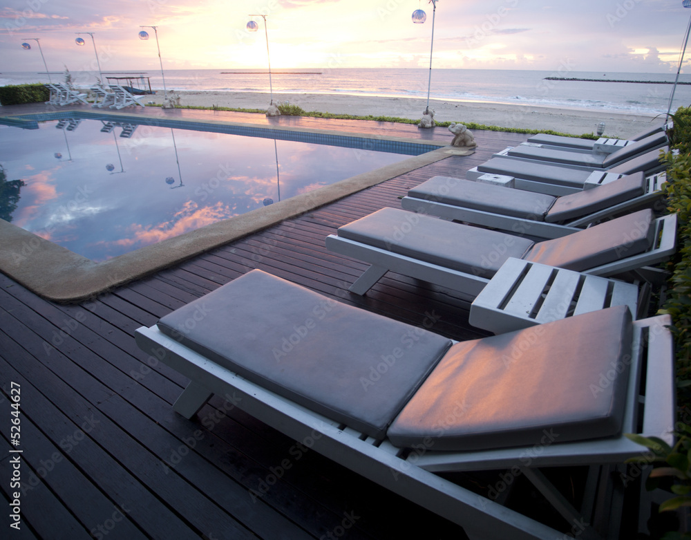Obraz premium Bed seaside pool near sunset.
