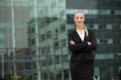 Confident young business woman standing outdoors