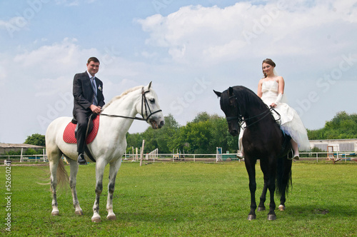 Wedding bride and groom on horseback