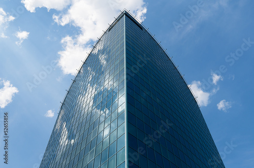 Sky reflections in glass walls of building