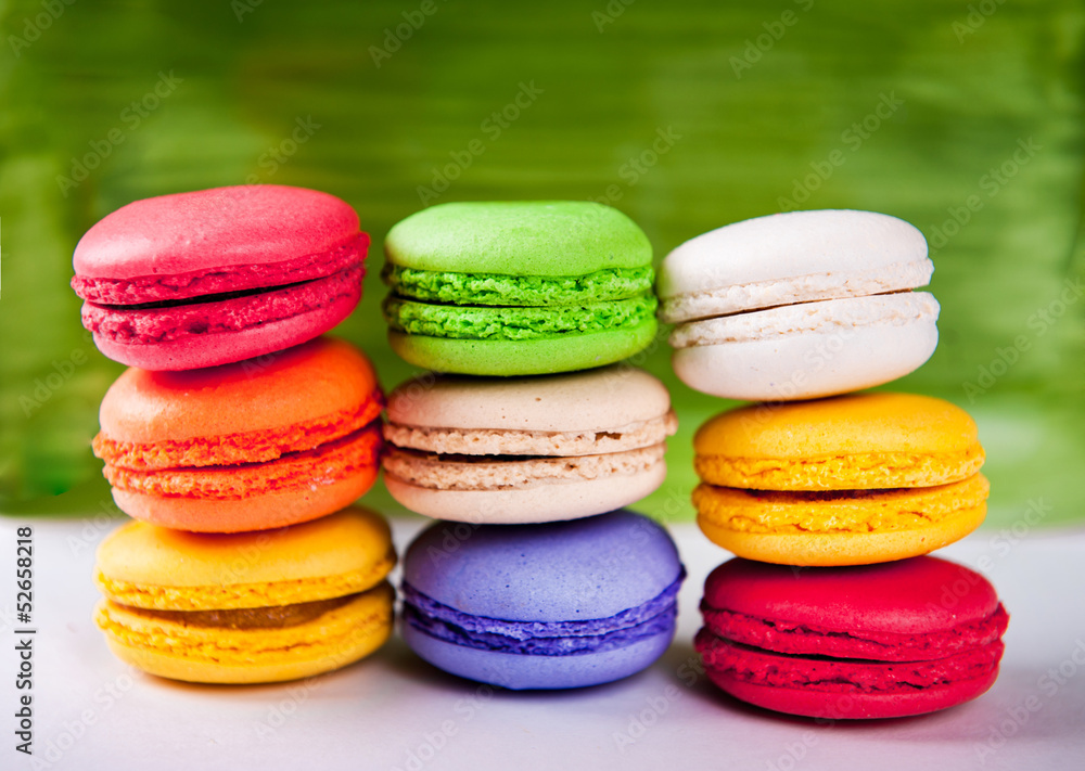 Colorful macaroons isolated against a green background Colorful macaroons isolated against a green background
