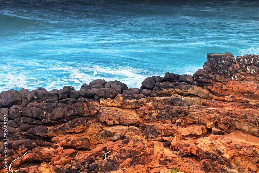 Blue ocean and red rocks in Australia