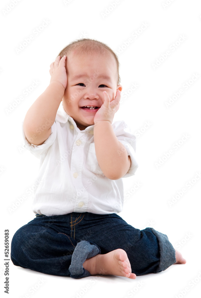 Portrait of a cute asian boy sitting on the floor Portrait of a cute asian boy sitting on the floor