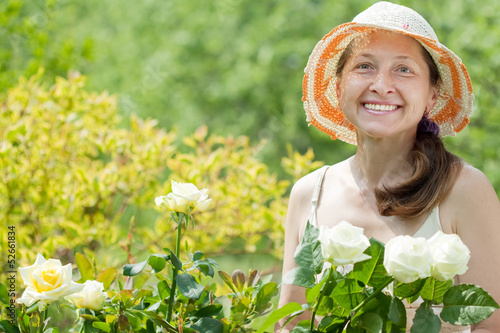 Female gardener in rose plant