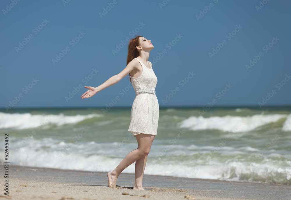 Redhead girl on the beack in spring time Redhead girl on the beack in spring time