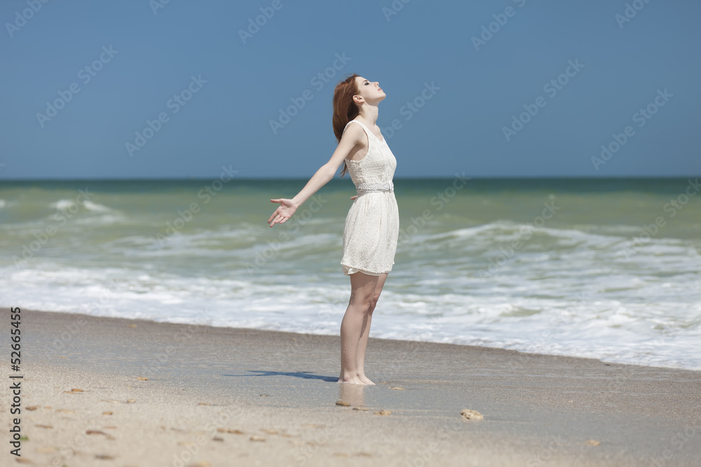 Redhead girl on the beack in spring time