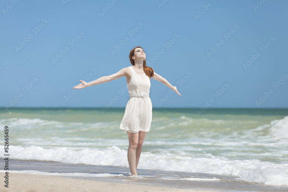Redhead girl on the beack in spring time Redhead girl on the beack in spring time
