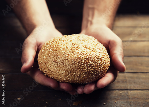 Baker's hands with a bread