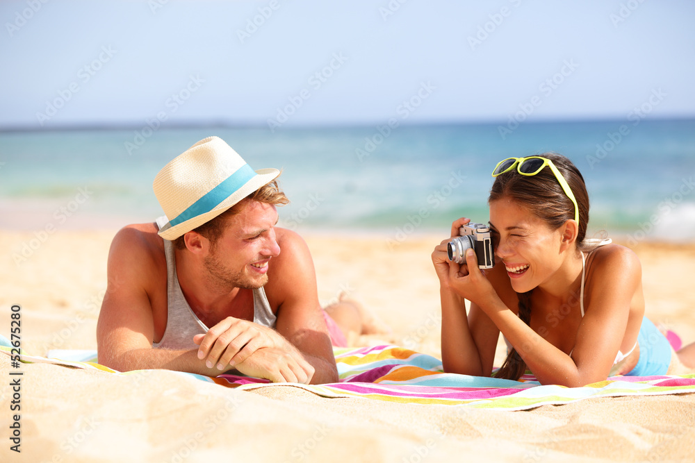 Beach fun couple travel - woman taking photo