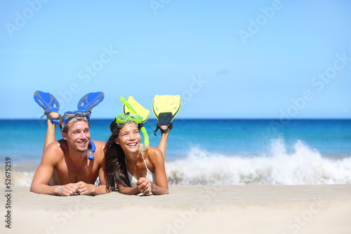Beach travel couple having fun snorkeling looking