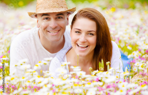 Happy couple on daisy field