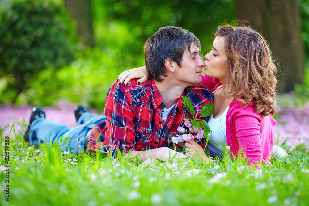 young tender couple in spring park young tender couple in spring park