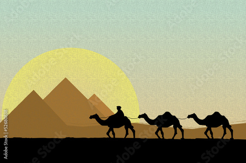 Bedouin camel caravan and pyramid silhouette