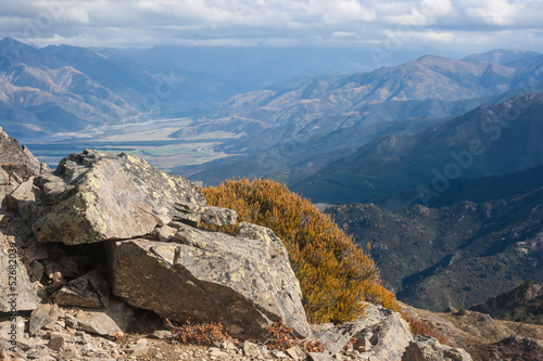 rocks and alpine vegetation with Lewis Pass in background © Patrik Stedrak