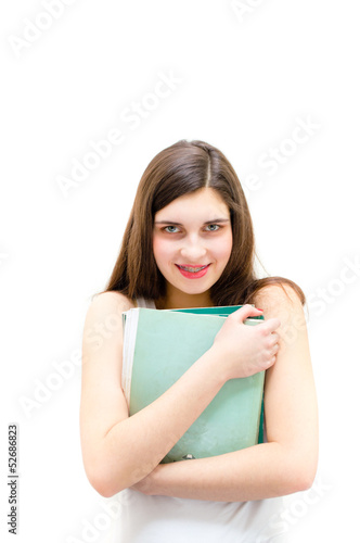 Teenage girl holding book and looking happy on white