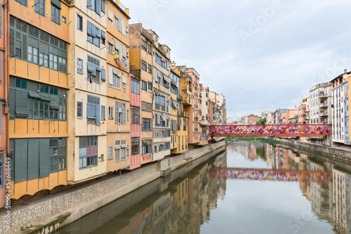 View of Girona with colorful houses reflected in water  Spain